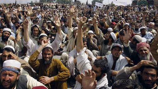 Pakistani tribesmen chant slogans as they protest in Jallozai camp, on outskirts of Nowshera
